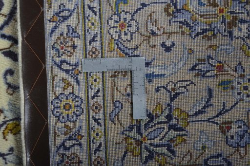 Backside of handmade 2000s Kashan rug showing knot structure and weave density