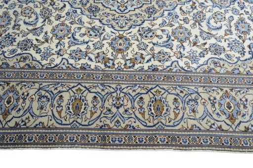 Corner detail of 2000s Kashan rug showing border pattern and Wool pile