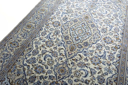 Backside of handmade 2000s Kashan rug showing knot structure and weave density