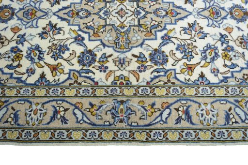 Corner detail of 2000s Kashan rug showing border pattern and Wool pile