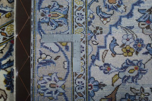 Backside of handmade 2000s Kashan rug showing knot structure and weave density