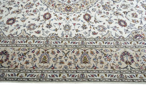 Corner detail of 2000s Kashan rug showing border pattern and Wool pile