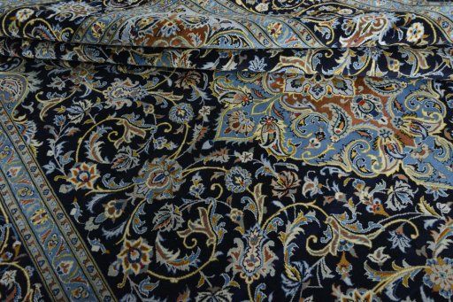 Close-up detail of 2000s Kashan rug from Iran / Persia showing Wool weave