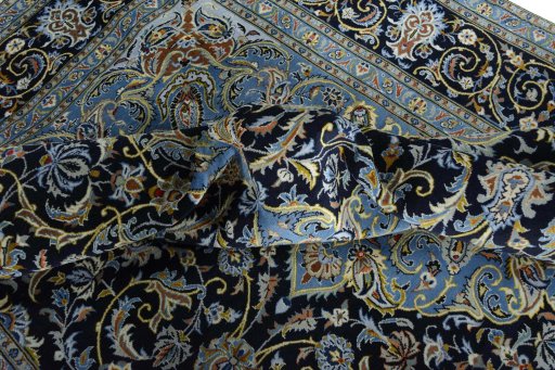 Surface texture of 2000s Kashan rug with natural Wool and intricate pattern