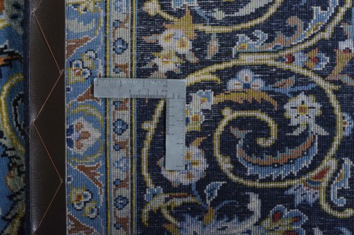 Backside of handmade 2000s Kashan rug showing knot structure and weave density
