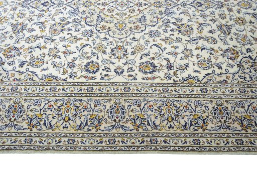 Corner detail of 2000s Kashan rug showing border pattern and Wool pile