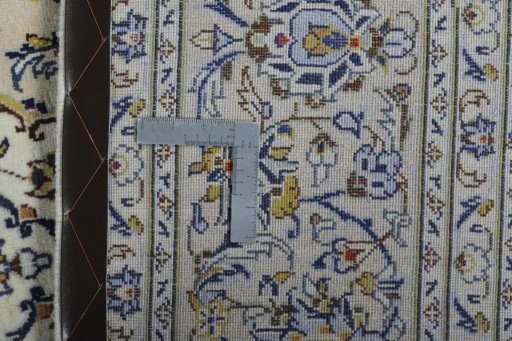 Backside of handmade 2000s Kashan rug showing knot structure and weave density