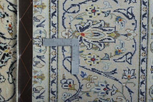 Backside of handmade 2000s Kashan rug showing knot structure and weave density