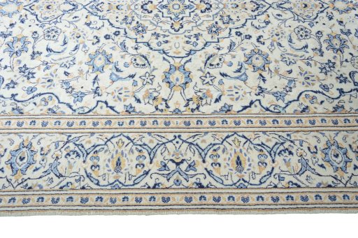 Corner detail of 2000s Kashan rug showing border pattern and Wool pile