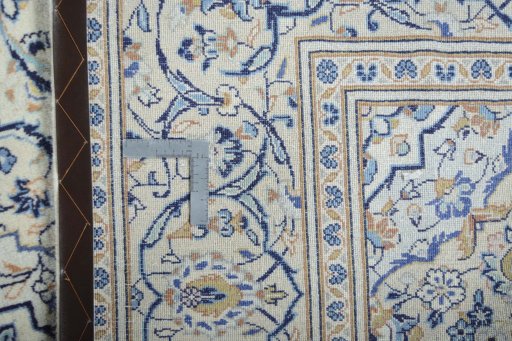 Backside of handmade 2000s Kashan rug showing knot structure and weave density
