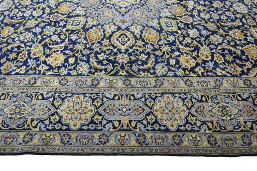 Corner detail of 2000s Kashan rug showing border pattern and Wool pile