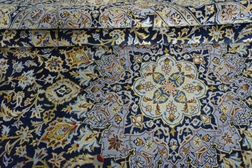 Close-up detail of 2000s Kashan rug from Iran / Persia showing Wool weave