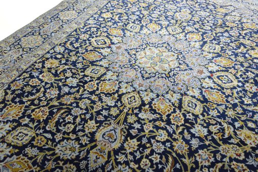 Backside of handmade 2000s Kashan rug showing knot structure and weave density