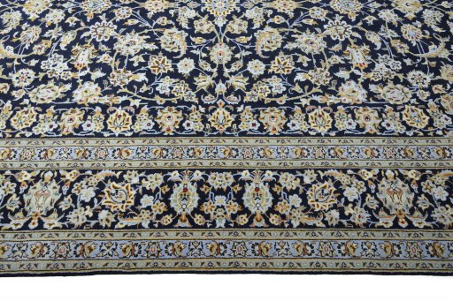 Corner detail of 2000s Kashan rug showing border pattern and Wool pile