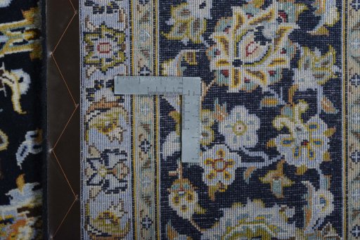 Backside of handmade 2000s Kashan rug showing knot structure and weave density