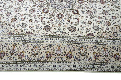 Corner detail of 2000s Kashan rug showing border pattern and Wool pile