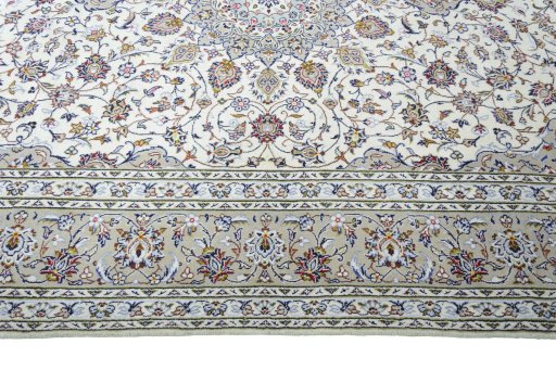 Corner detail of 2000s Kashan rug showing border pattern and Wool pile