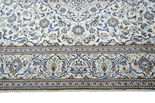 Corner detail of 2000s Kashan rug showing border pattern and Wool pile