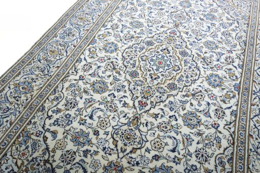 Backside of handmade 2000s Kashan rug showing knot structure and weave density