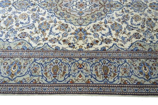 Corner detail of 2000s Kashan rug showing border pattern and Wool pile