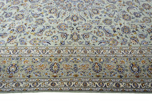 Corner detail of 2000s Kashan rug showing border pattern and Wool pile