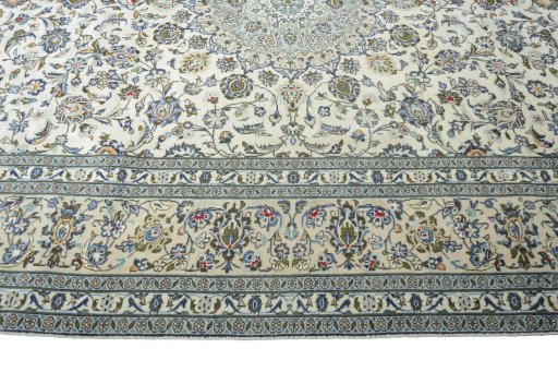 Corner detail of 2000s Kashan rug showing border pattern and Wool pile