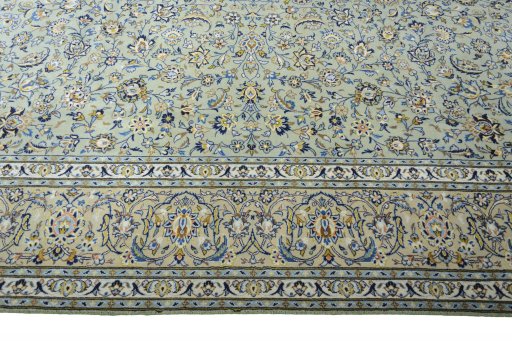 Corner detail of 2000s Kashan rug showing border pattern and Wool pile