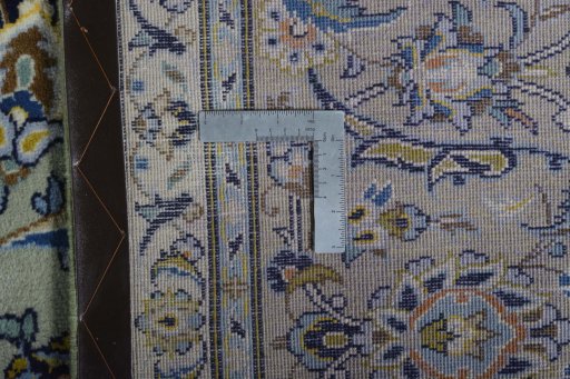 Backside of handmade 2000s Kashan rug showing knot structure and weave density