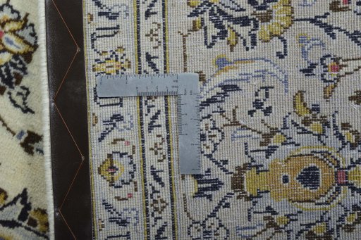 Backside of handmade 2000s Kashan rug showing knot structure and weave density