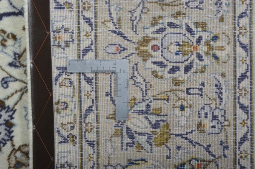Backside of handmade 2000s Kashan rug showing knot structure and weave density