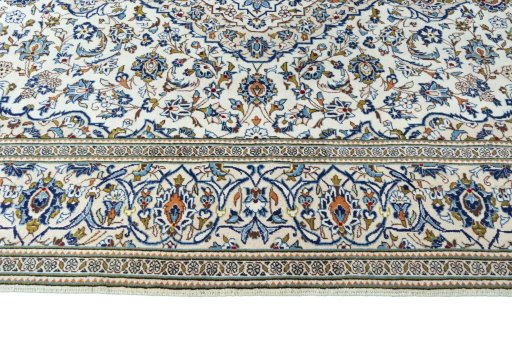 Corner detail of 2000s Kashan rug showing border pattern and Wool pile