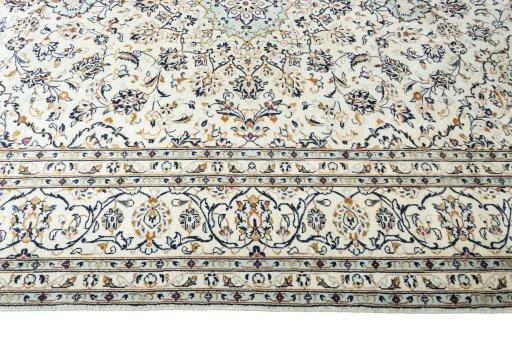Corner detail of 2000s Kashan rug showing border pattern and Wool pile
