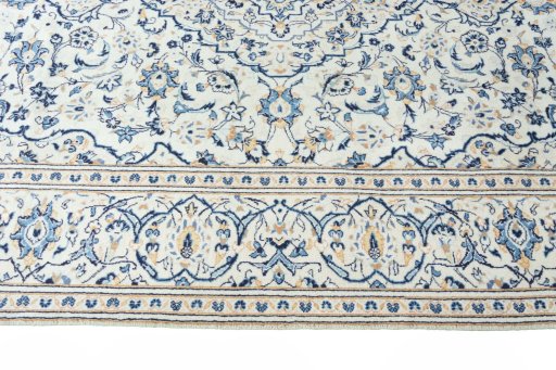 Corner detail of New Kashan rug showing border pattern and Wool pile