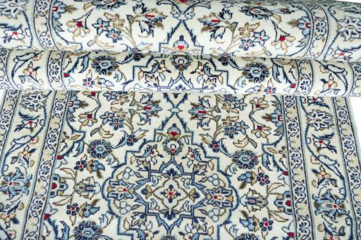 Corner detail of 2000s Kashan rug showing border pattern and Wool pile
