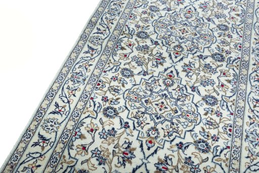 Backside of handmade 2000s Kashan rug showing knot structure and weave density