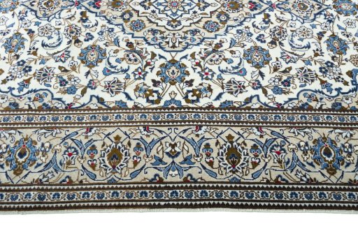 Corner detail of 2000s Kashan rug showing border pattern and Wool pile