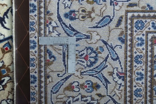 Backside of handmade 2000s Kashan rug showing knot structure and weave density