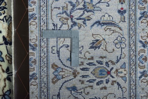 Backside of handmade New Kashan rug showing knot structure and weave density