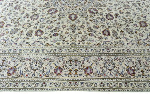 Corner detail of 2000s Kashan rug showing border pattern and Wool pile
