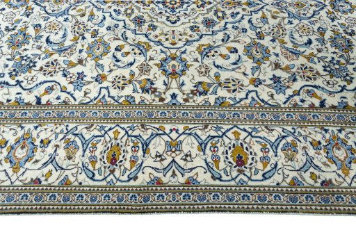 Corner detail of 2000s Kashan rug showing border pattern and Wool pile