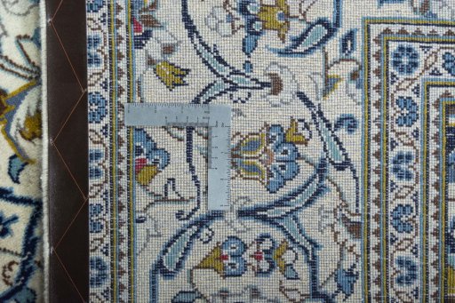 Backside of handmade 2000s Kashan rug showing knot structure and weave density