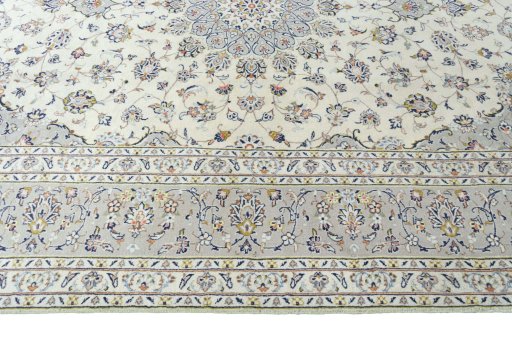 Corner detail of 2000s Kashan rug showing border pattern and Wool pile