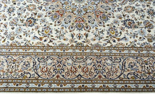 Corner detail of 2000s Kashan rug showing border pattern and Wool pile