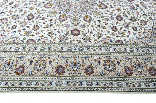 Corner detail of 2000s Kashan rug showing border pattern and Wool pile