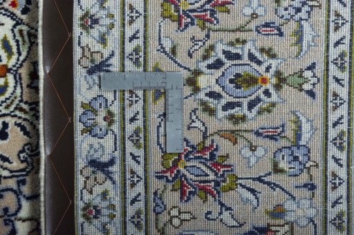 Backside of handmade 2000s Kashan rug showing knot structure and weave density