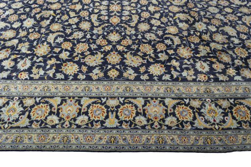 Corner detail of 2000s Kashan rug showing border pattern and Wool pile