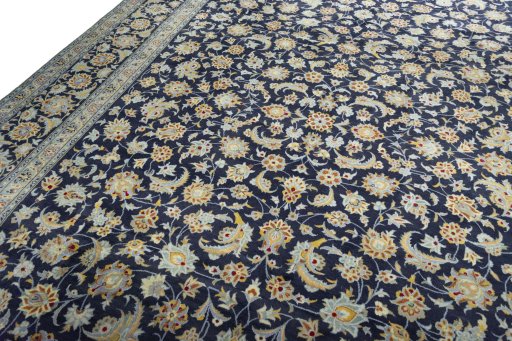 Backside of handmade 2000s Kashan rug showing knot structure and weave density