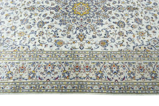 Corner detail of 2000s Kashan rug showing border pattern and Wool pile