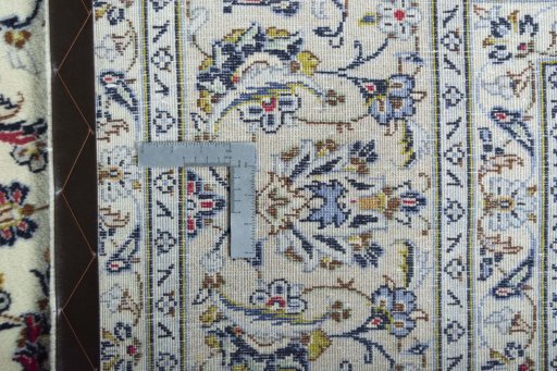 Backside of handmade 2000s Kashan rug showing knot structure and weave density