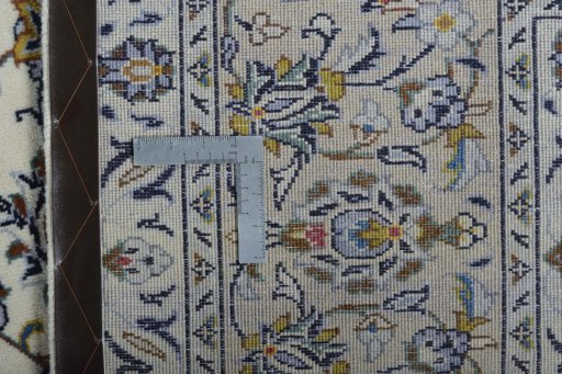 Backside of handmade New Kashan rug showing knot structure and weave density